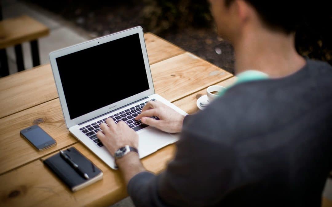 man in front of laptop computer in shallow focus photography